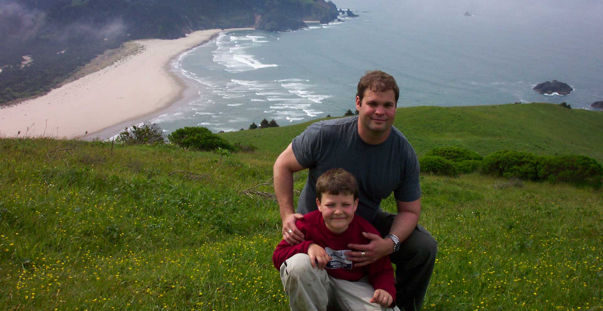 man and boy with a seaside background