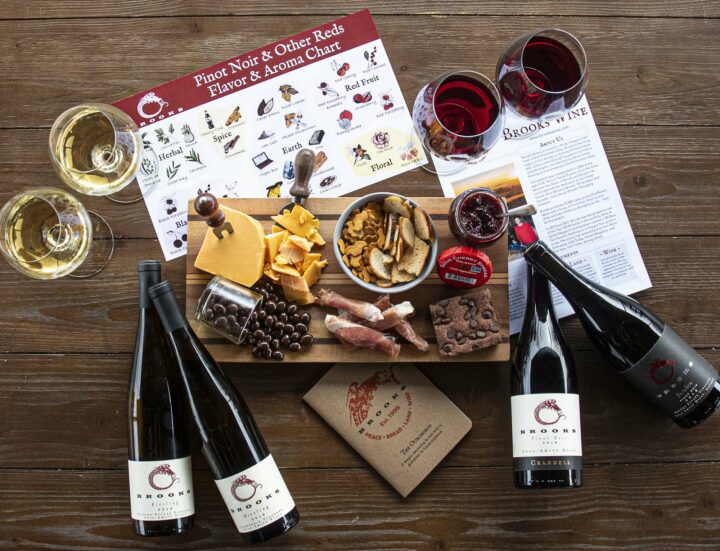 Four bottles of Brooks wine plus food items and Brooks Scout Book and our Brooks flavor and aroma charts.