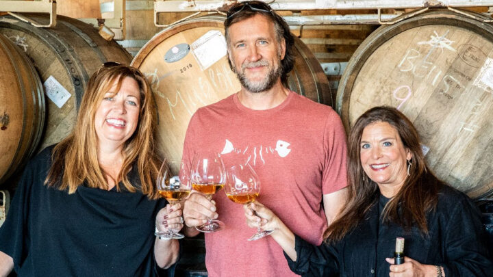 Director of Club Happiness, Heather. Winemaker Chris Williams. Operating Manager Janie. All three cheersing a glass of Brooks Rose. 