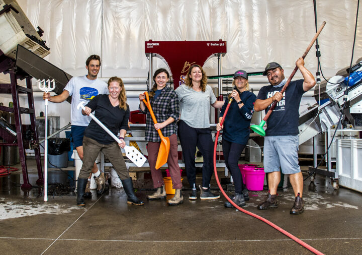 The 2021 Harvest interns in front of the red wine press