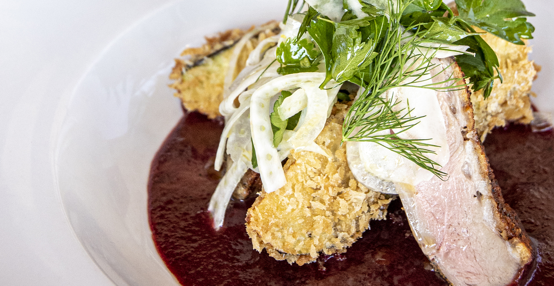 Seared duck breast with fried eggplant, a cherry demi-sauce and a fennel & herb salad