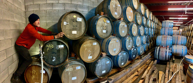 Winemaker Chris Williams tasting in the barrel room