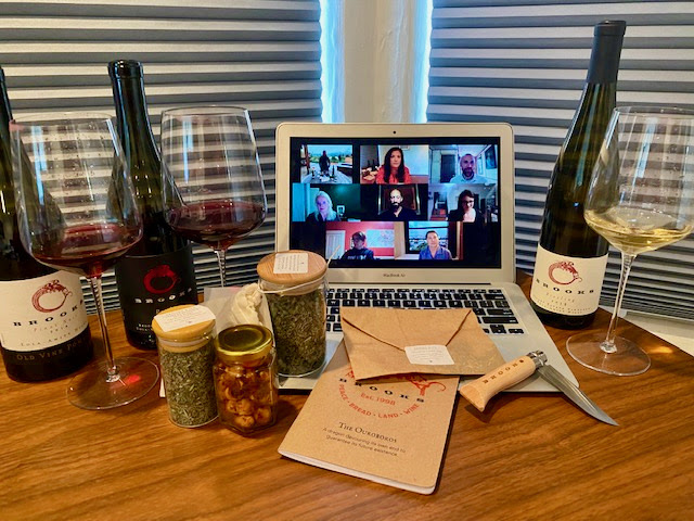 A virtual tasting with a computer, three bottles, and three glasses of Brooks Wine.