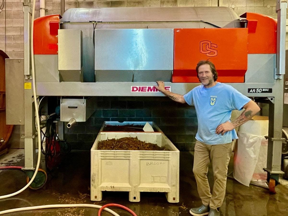 Winemaker Chris Williams in front of the white wine press