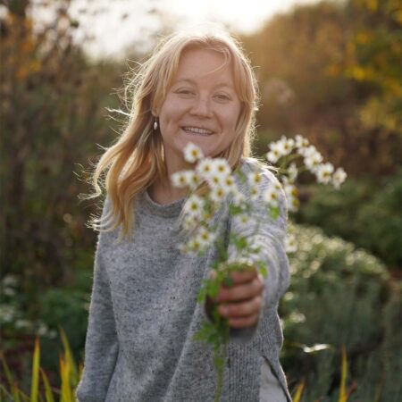 Shannon smiling at camera and sharing wildflowers from Brooks garden