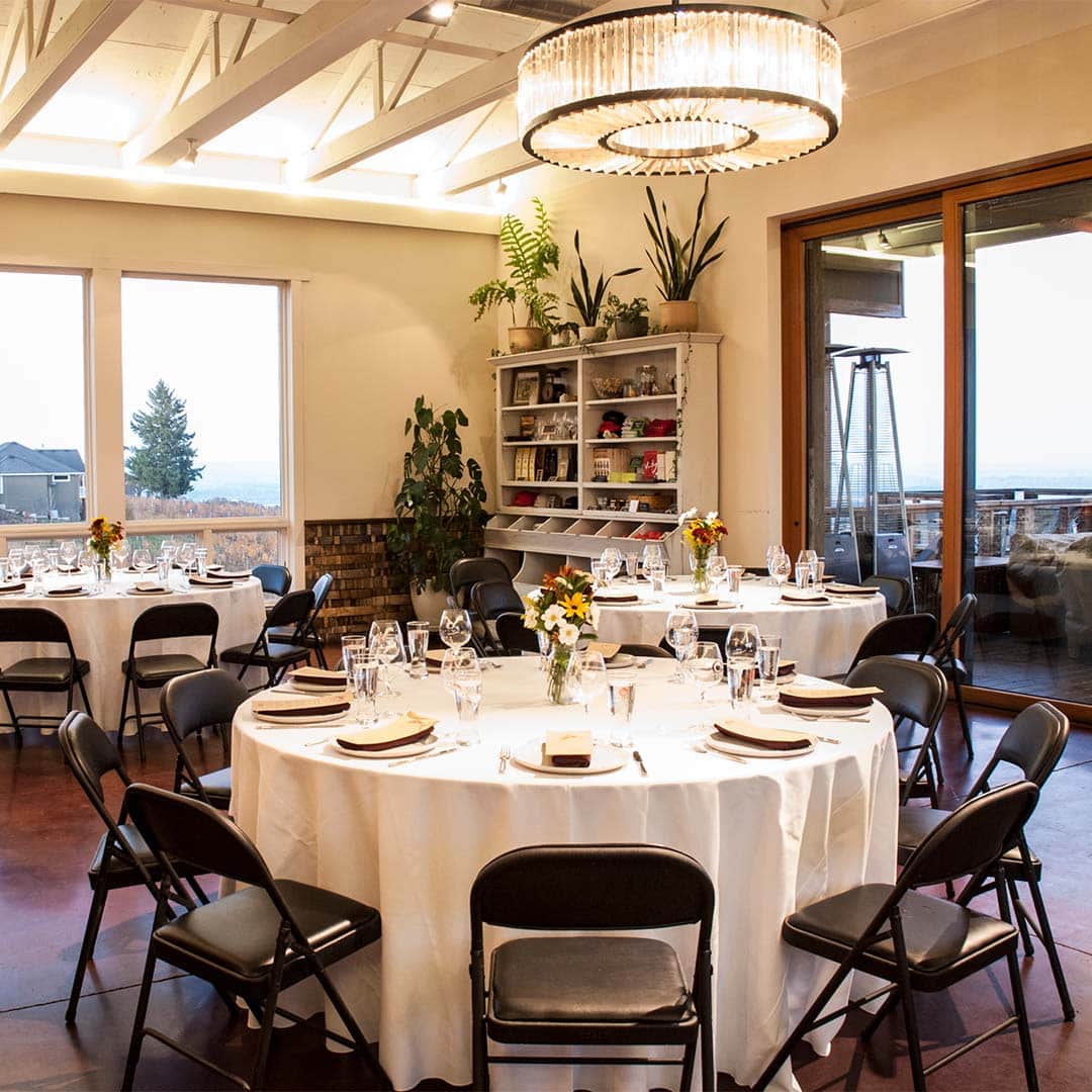 Brooks tasting room set with round tables each seating 10 people.