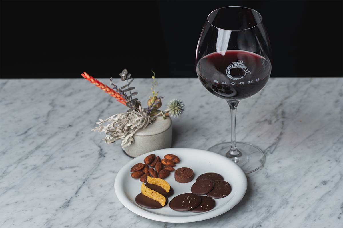 Glass of Brooks red wine with variety of chocolate bites