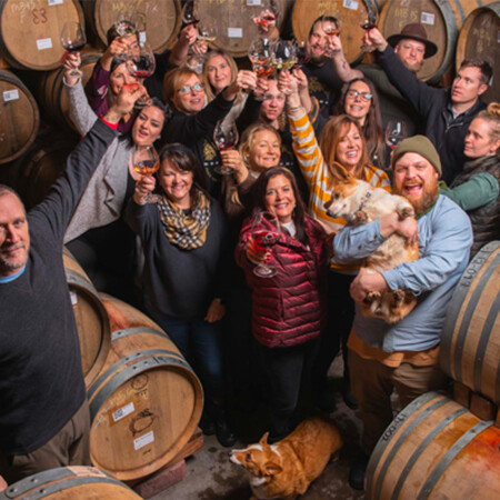 Brooks staff in barrel room all smiling at camera