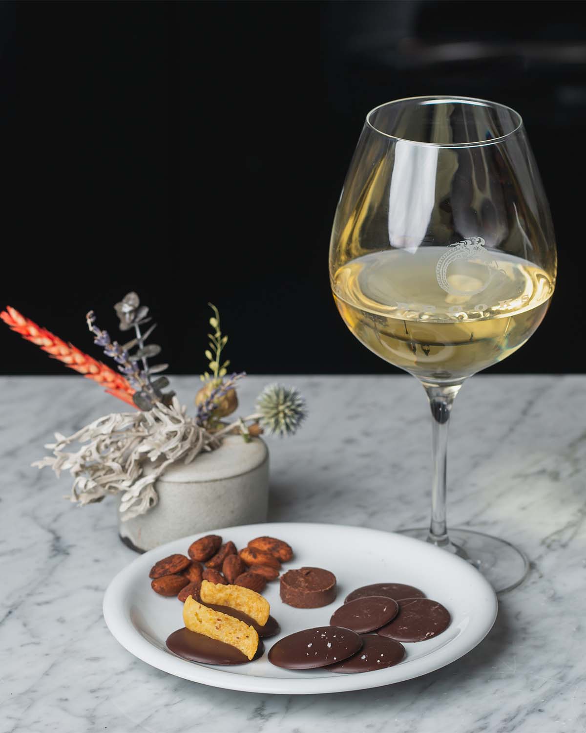Glass of Brooks Riesling with various chocolate bites