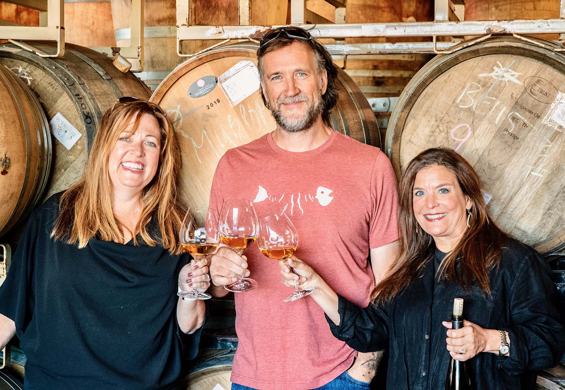 Heather, Chris, and Janie drinking wine in the Brooks Barrel Room