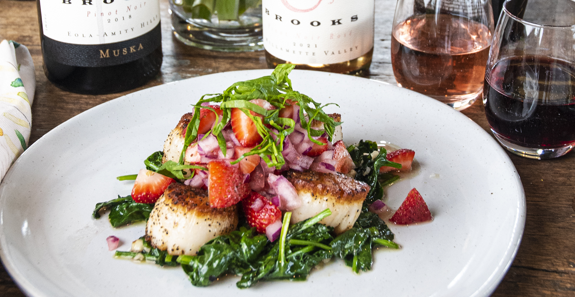 Seared sea scallops with a strawberry, red onion salsa and garlic-wilted spinach