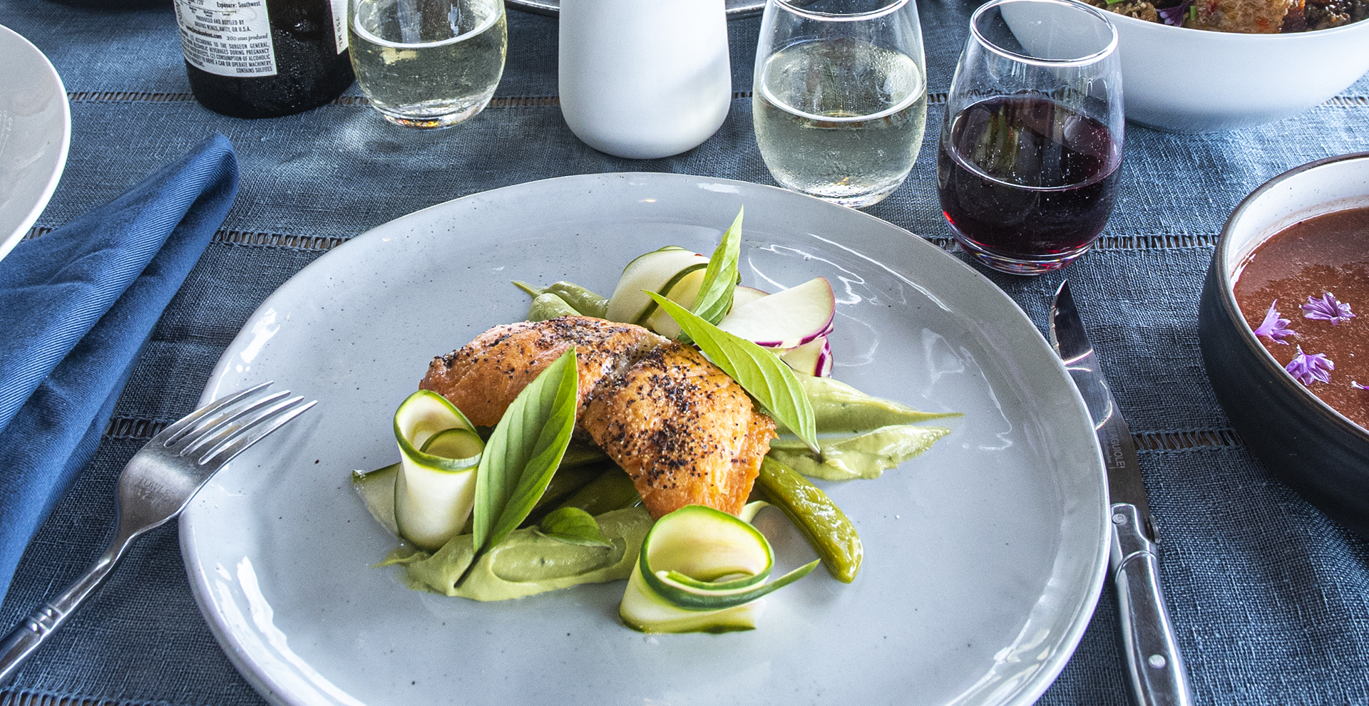 Pan-seared king salmon with an avocado mousse, snap peas, and pickled cucumber ribbons