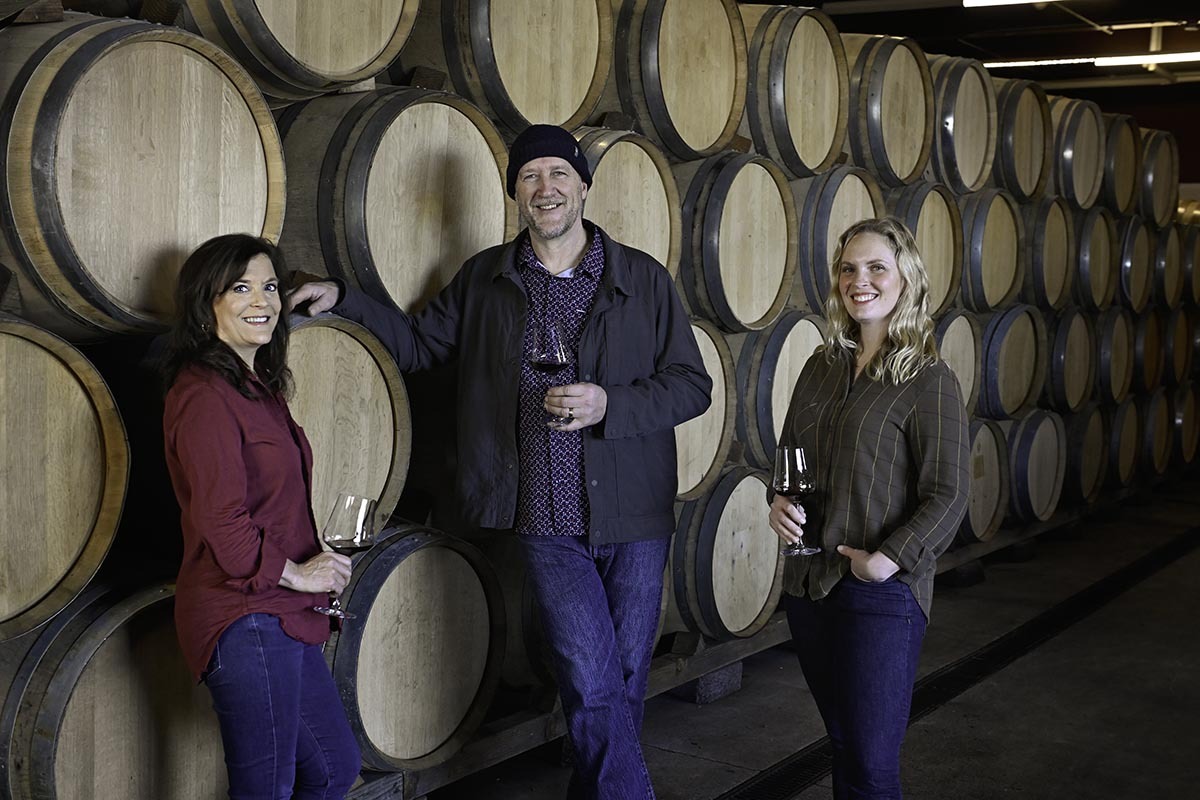 Claire Jarreau, newly appointed Head Winemaker at Brooks Winery, stands in the Barrel Room alongside esteemed Winemaker and mentor, Chris Williams, and Managing Director, Janie Heuck. 