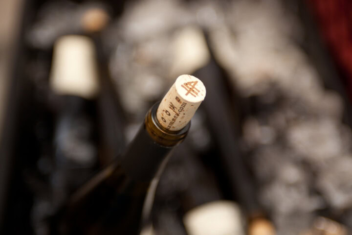 A cork emerges from a wine bottle.