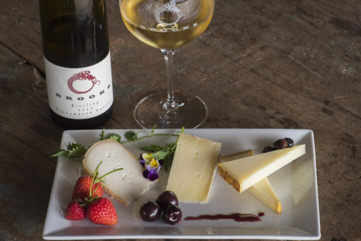 A selection of three cheeses and berries to be used in a wine and cheese pairing with Brooks Wine Riesling. 