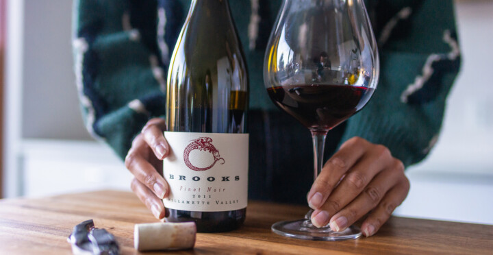 Bottle of wine with woman's hands
