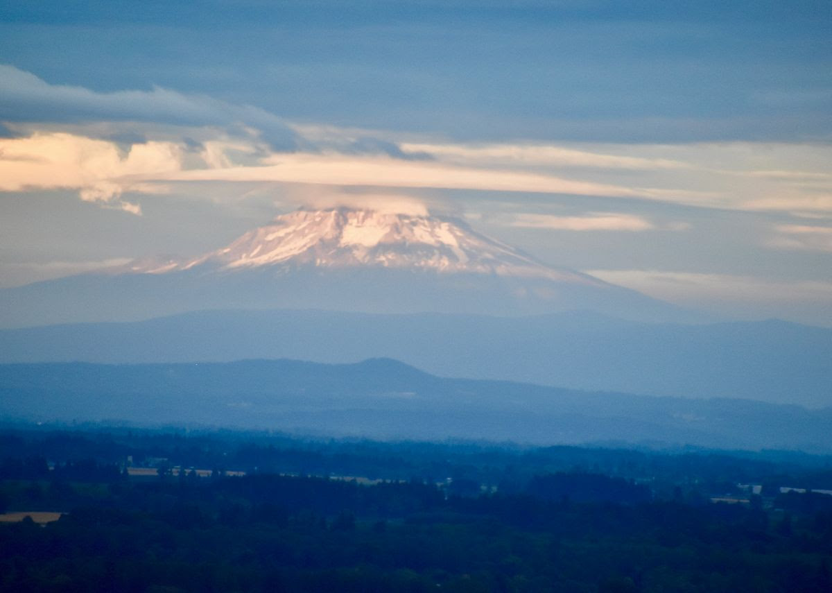 Mt Hood in Willamette Valley peaks out from the clouds and beckons athletes from near and far to hike up and ski down.