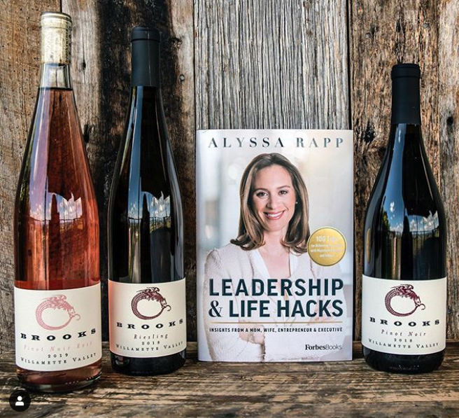 Three bottles of Brooks Wines with the book Leadership and Life Hacks
